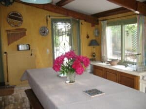 The dining room was just off the kitchen and became our favorite room in the house. The yellow walls and many windows gave it a sun-room feel. Fresh pink peonies were there when we arrived.